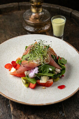 Salad with strawberries, parmesan and prosciutto. 