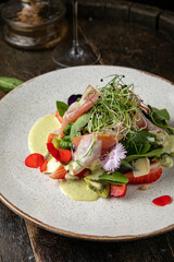 Salad with strawberries, parmesan and prosciutto. 