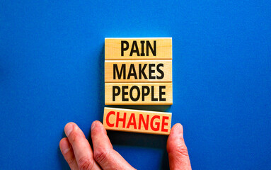 Pain makes people change symbol. Concept words Pain makes people change on wooden blocks on a beautiful blue table blue background. Business, motivational and pain makes people change concept.