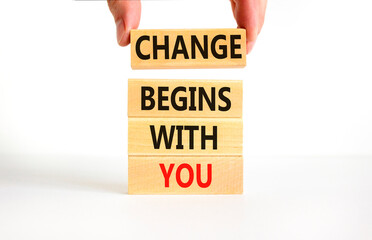 Change begins with you symbol. Concept words Change begins with you on wooden blocks on beautiful white table white background. Businessman hand. Business motivational change begins with you concept.