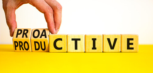 Proactive and productive symbol. Businessman turns cubes and changes the concept word Productive to...