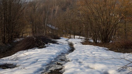 Path on the snow-capped top of the mountain, view from above.