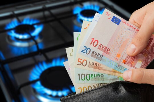 The banknotes with burning gas burner. The concept is to increase the cost of supply. The energy crisis.