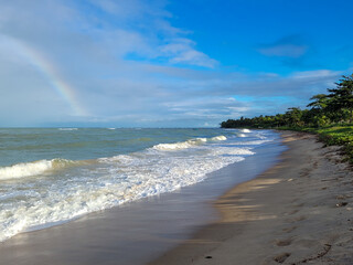 Fototapeta na wymiar fisherman's beach with clouds and shy sun after rain, Arrial D'Ajuda, Bahia, Brazil