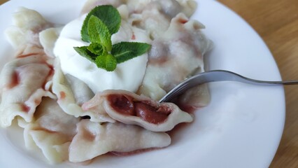 dumplings with cherries on a plate