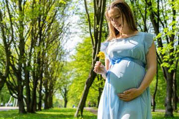 Pregnancy woman walk. Pregnant nature walk. Happy maternity mother in summer park. Baby belly. Pregnancy activity.