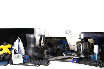 Old computers, digital tablets, mobile phones, many used electronic gadgets devices, broken household and appliances. Planned obsolescence, electronic waste for recycling concept