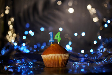 Digital gift card birthday concept. Tasty fresh homemade vanilla cupcake with number 14 fourteen on...