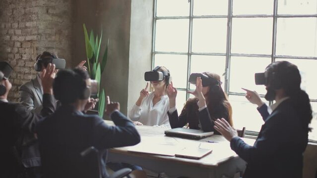 business people in office developing a project using virtual reality goggles. colleagues using headsets while sitting working desk