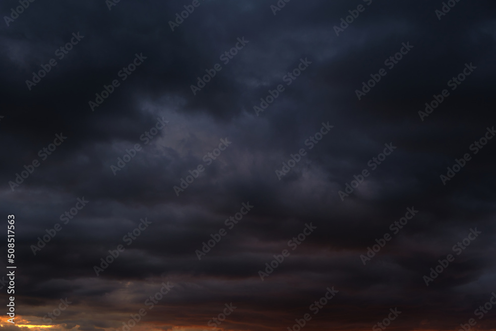 Wall mural thunderstorm dramatic clouds during evening sunset.