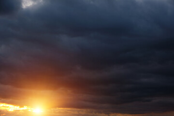 Fototapeta na wymiar Thunderclouds with breaking rays sun at sunset.
