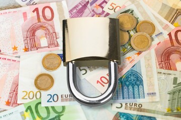 Padlock on money. Economic sanctions such as retaliation for war.