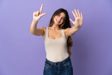 Young caucasian woman isolated on purple background counting seven with fingers