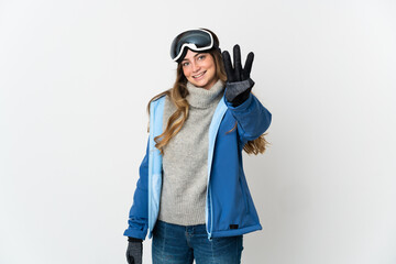 Skier girl with snowboarding glasses isolated on white background happy and counting three with fingers