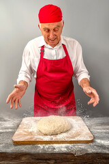 Chef-cooker in chef's hat and apron working in bakery, kneading dough for bread. Senior professional baker man wearing chef's outfit. Character kitchener, pastry chef for advertising