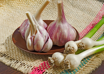 Garlic cloves in a bowl on burlap.