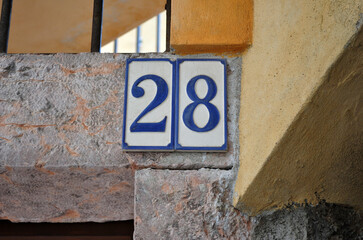 Close Up of Ceramic Sign Numbers 28  on Old Building 