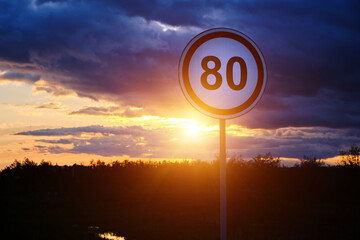 Speed limit sign of 80 km h background bright sunset and clouds. - obrazy, fototapety, plakaty