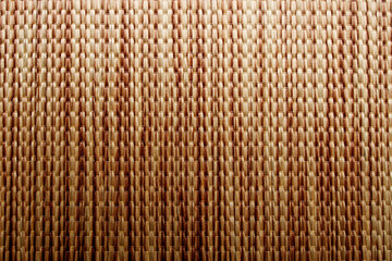 Wicker background made of natural straw. Full frame of densely woven straw pattern. Natural, natural background