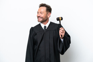 Middle age judge man isolated on white background looking to the side and smiling