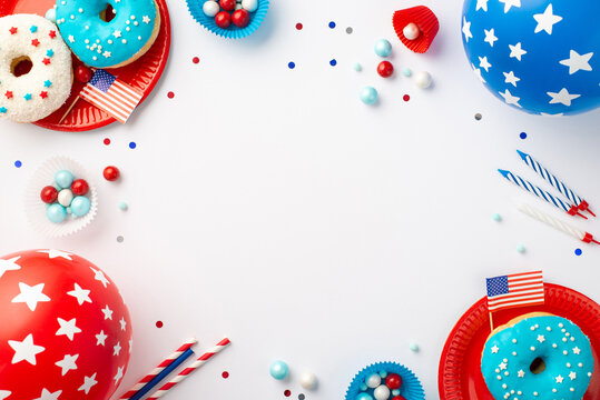 Fourth of July concept. Top view photo of US national flags balloons confetti candles paper baking molds straws candies and plates with donuts on isolated white background with copyspace