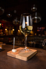 Dry white wine and a piece of brie cheese