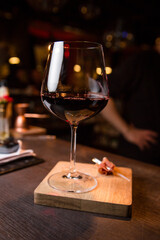 Red wine in a glass and a slice of jamon