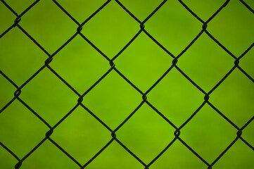 Fototapeta na wymiar metal mesh,in the photo a mesh on a green background