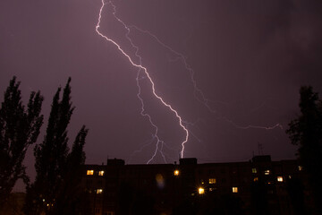 Lightning at night with heavy rain and thunder over Ukraine, lightning over the city in the night sky