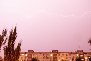 Lightning at night with heavy rain and thunder over Ukraine, lightning over the city in the night sky