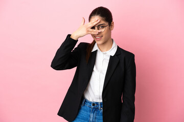 Young caucasian business woman isolated on pink background covering eyes by hands and smiling