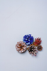 Eco friendly Christmas, New Year decorations, multicolored painted natural pine, fir cones, no plastic concept. Copy space.