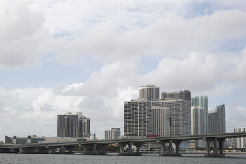 Fototapeta na wymiar Some buildings and a bridge in Miami, Florida with a sky full of clouds in the background