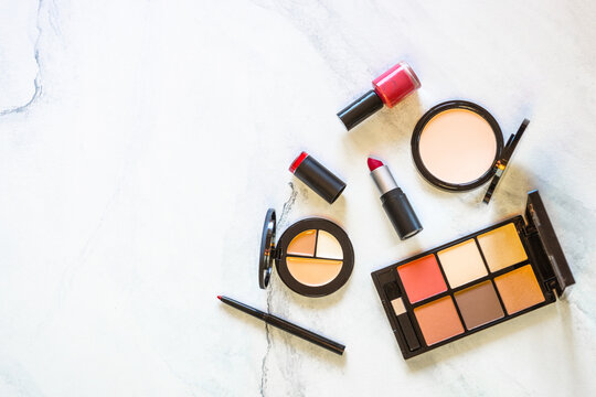 Makeup professional cosmetics on white marble background. Flat lay image with copy space.