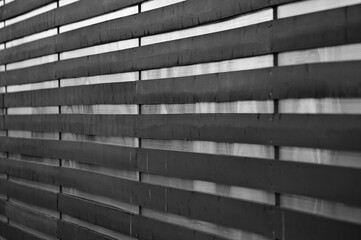 gray background, in the photo a fence made of wooden boards in close-up