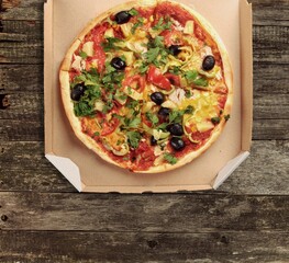 Traditional pizza with cheese and meat on wood desk. Pizza with four cheese combination. Cheese pizza.