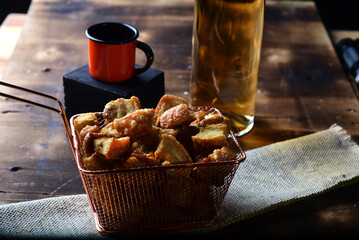 delicious fried and roasted pork skin, typical brazilian food, pancetta served in a metal basket