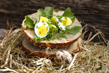 Roll topped with boiled quail eggs in hay nest