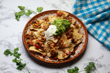 Nachos with guacamole and chilli con carne. Mexican food