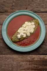 Grilled nopales with cheese and red sauce. Mexican food