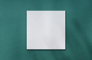 Blank white square frame for your content on teal paper texture. Retro colour background for your...