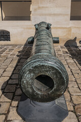 Historic Napoleonic artillery gun near Les Invalides in Paris. Les Invalides (National Residence of Invalids) - complex of museums and monuments relating to military history of France.