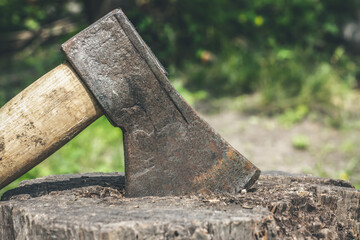 An ax stuck in a stump. Preparation of firewood.