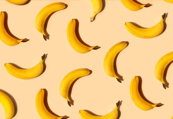 Yellow bananas pattern on a trendy beige background. Summer freshness, natural snack, organic. Healthy eating, raw food, vegan vitamins food concept. Bright abstract backdrop or wallpaper