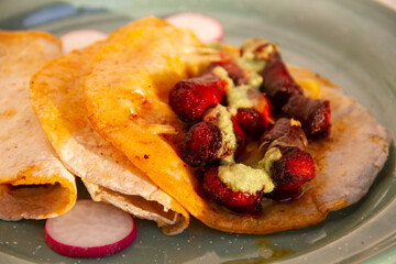 Chistorra quesadillas with green sauce. Mexican food