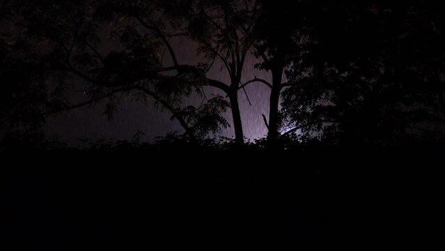 Bright flashing lights of exploded transformer burning on a cold wet evening during a thunder lightening storm downpour