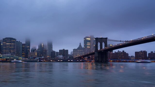 Timelapse of Manhattan skyline and Brooklin bridge at dusk, night to day transition, New York city