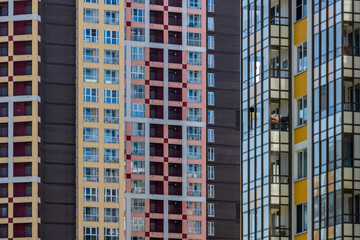 Fototapeta premium High-rise residential apartment buildings of dense development with a large number of windows and balconies.