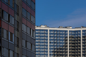 High-rise residential apartment buildings of dense development with a large number of windows and balconies.