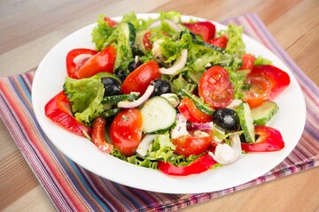 Fresh spring vegetable salad with tomatoes and peppers in the bowl.